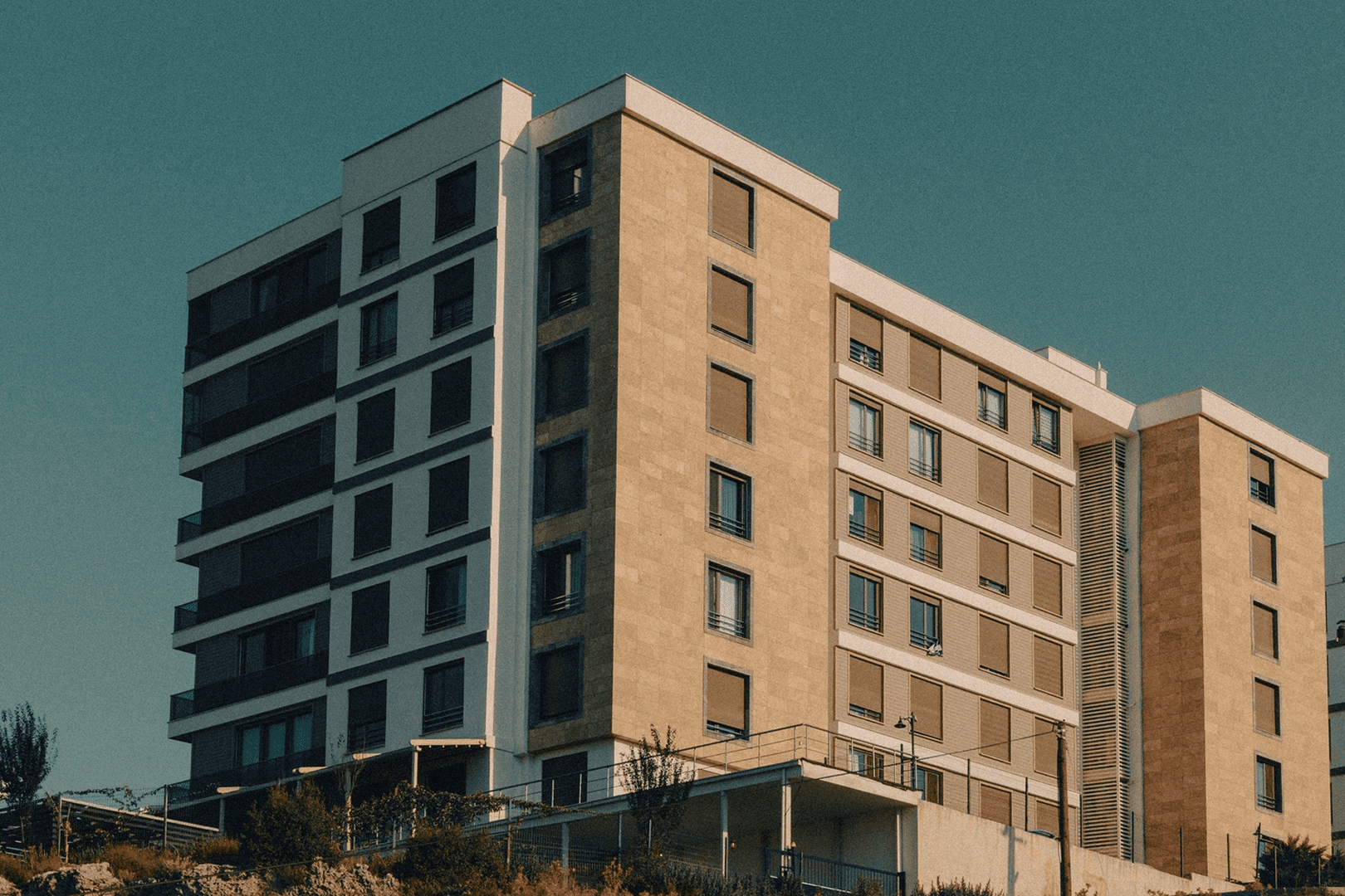 Modern apartment building under clear blue sky.